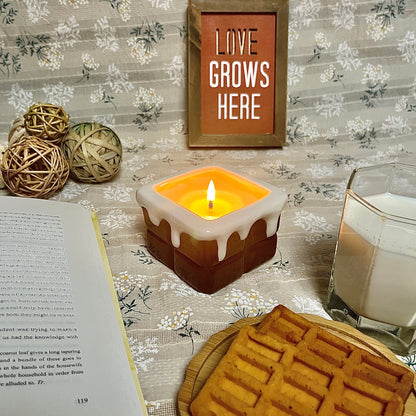 Chocolate ganache-scented ceramic soy candle glowing on a cozy tabletop with waffles, milk, an open book, and warm home décor accents.